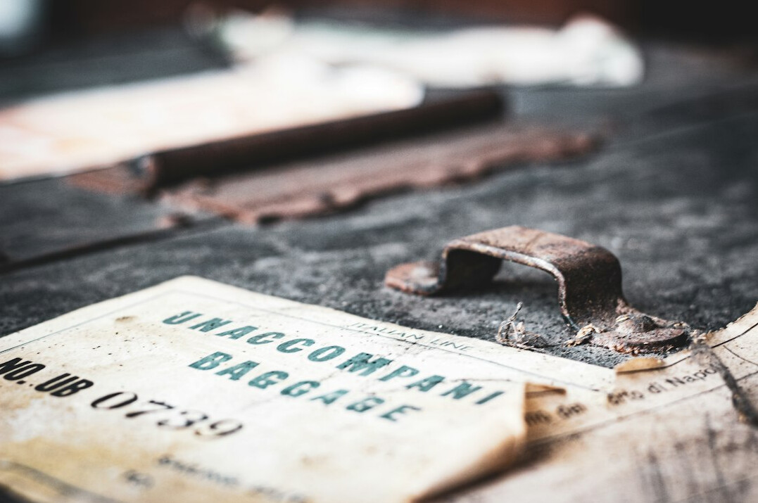 Old yellowed documents and magnifying glass on a wooden desk