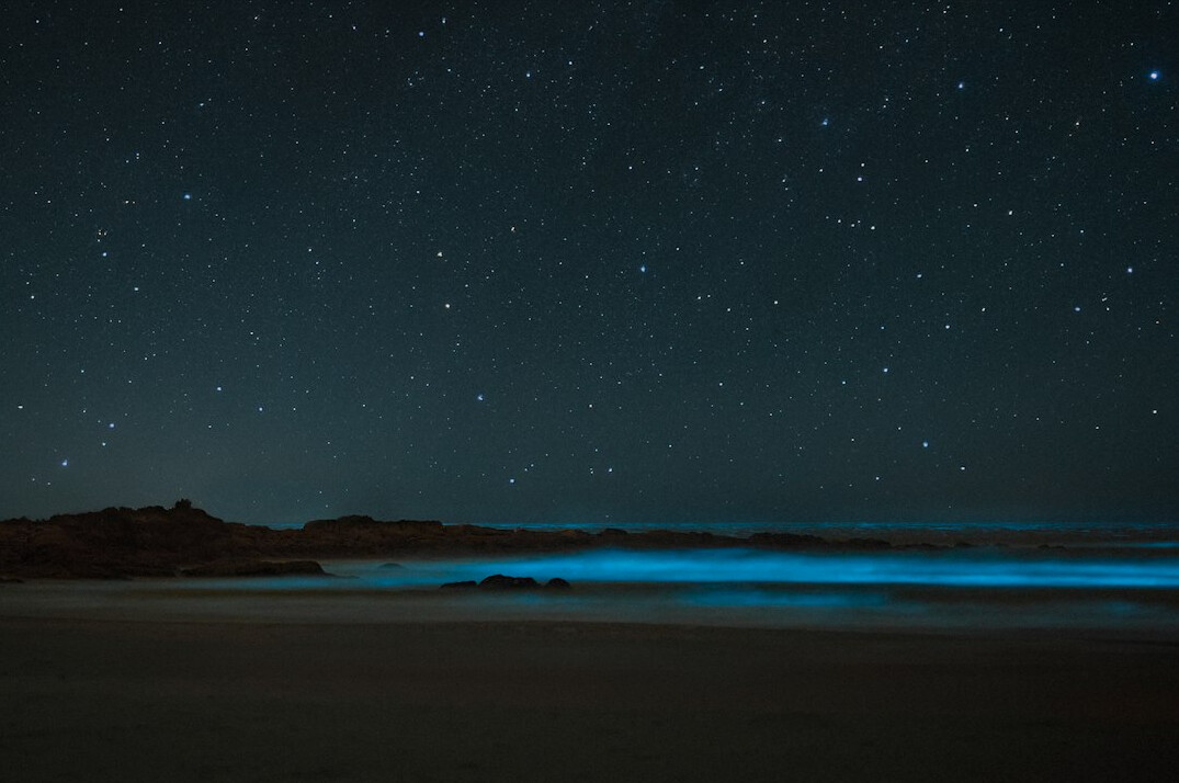 Misty lighthouse on the Uruguayan coast at night with starry sky
